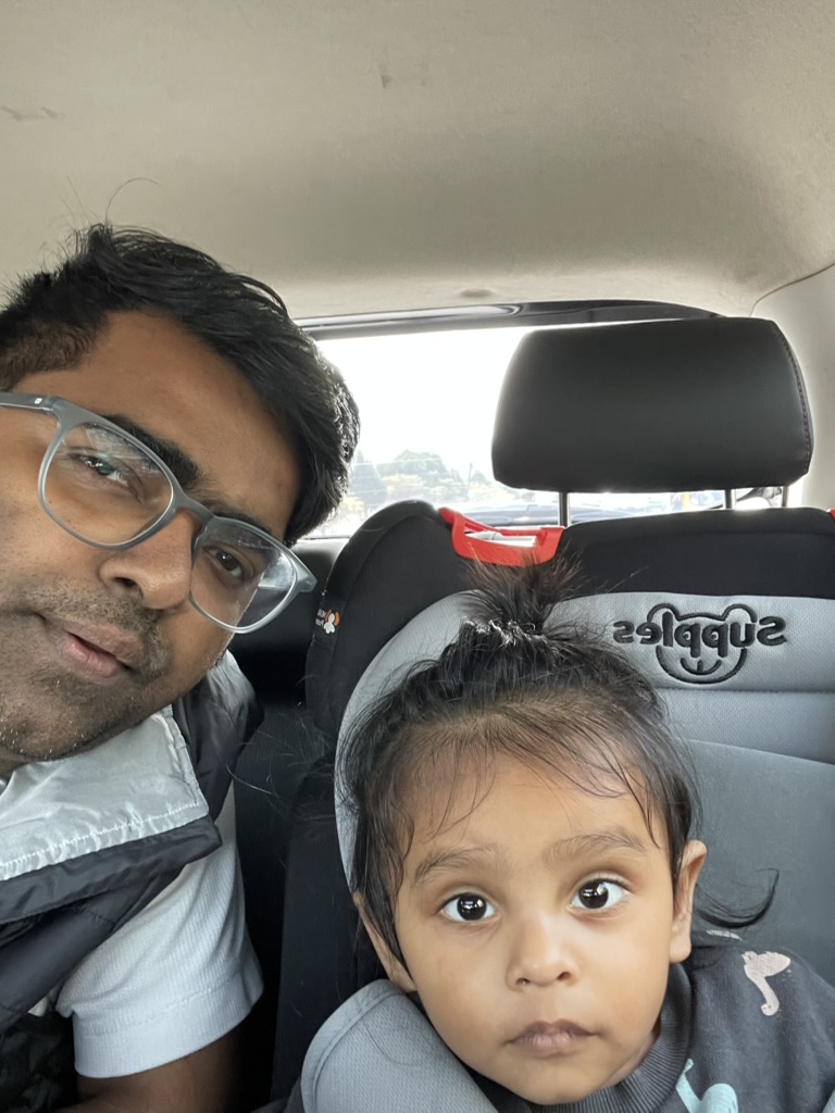 Satyartha sitting in a car seat with family
