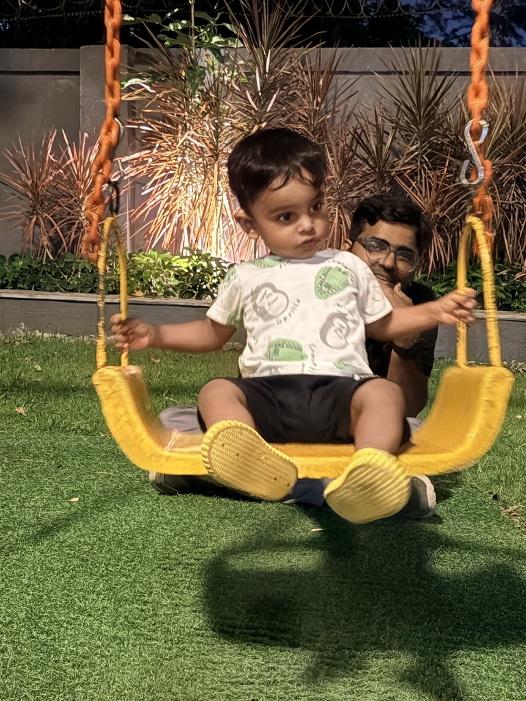 Satyartha sitting on a yellow swing