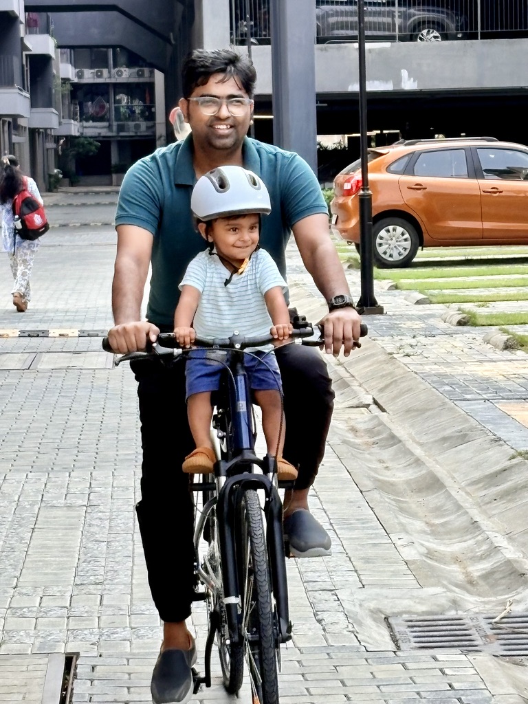 Satyartha smiling during a family bike ride