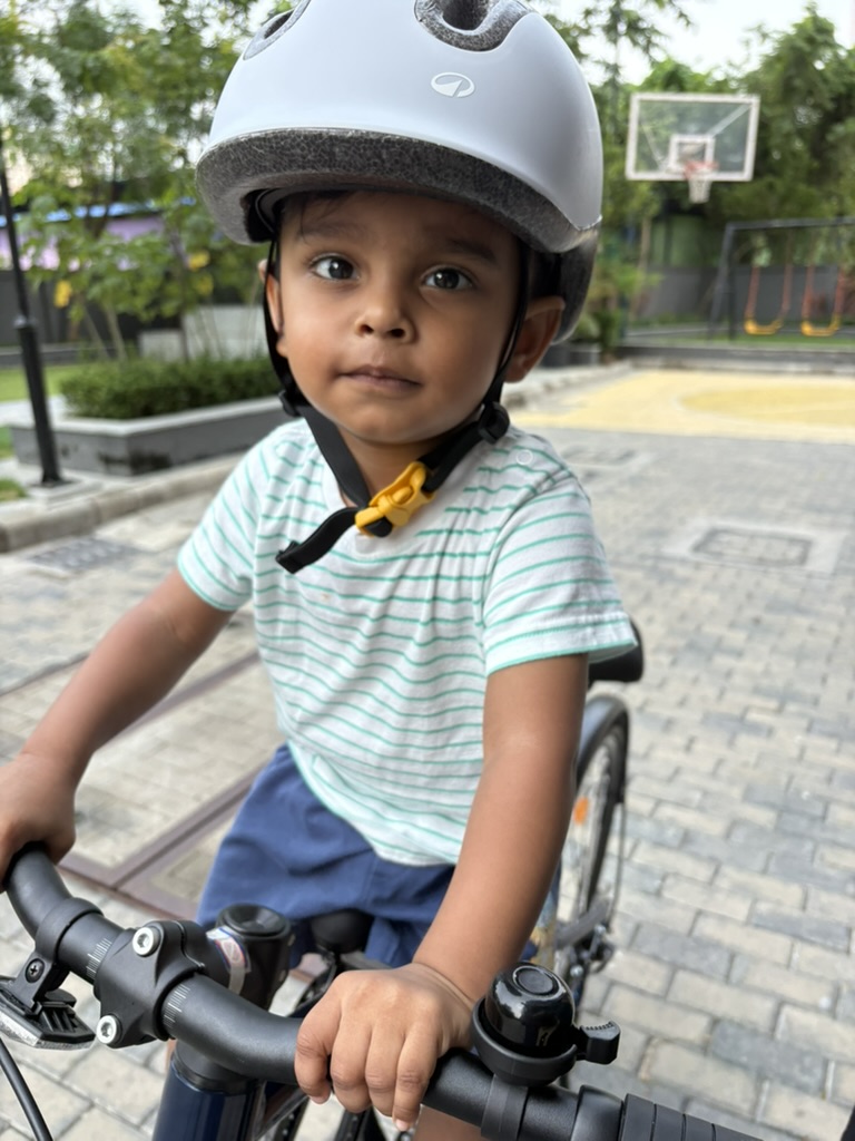 Satyartha wearing a helmet on a bicycle
